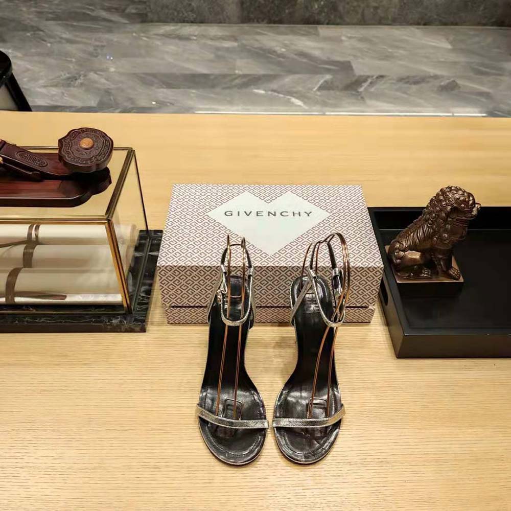 Close-up of signature G Cube geometric hardware on Givenchy silver sandals