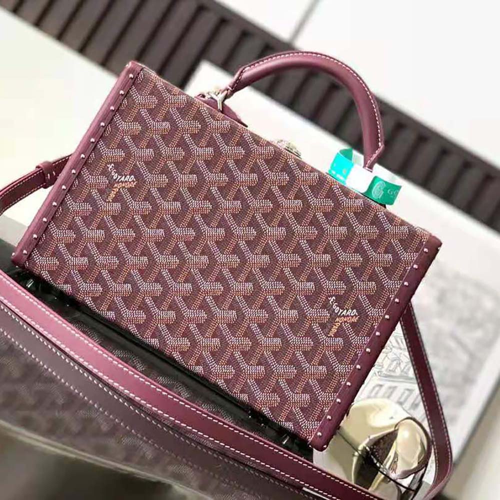 Side angle showcasing Goyardine canvas texture on Sac Malle Grand Hôtel