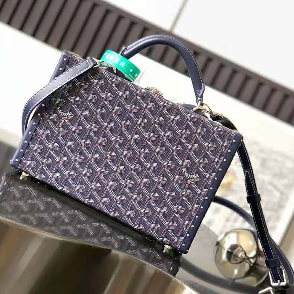 Side angle featuring brass hardware and shoulder strap on Goyard Women Sac Malle Grand Hôtel