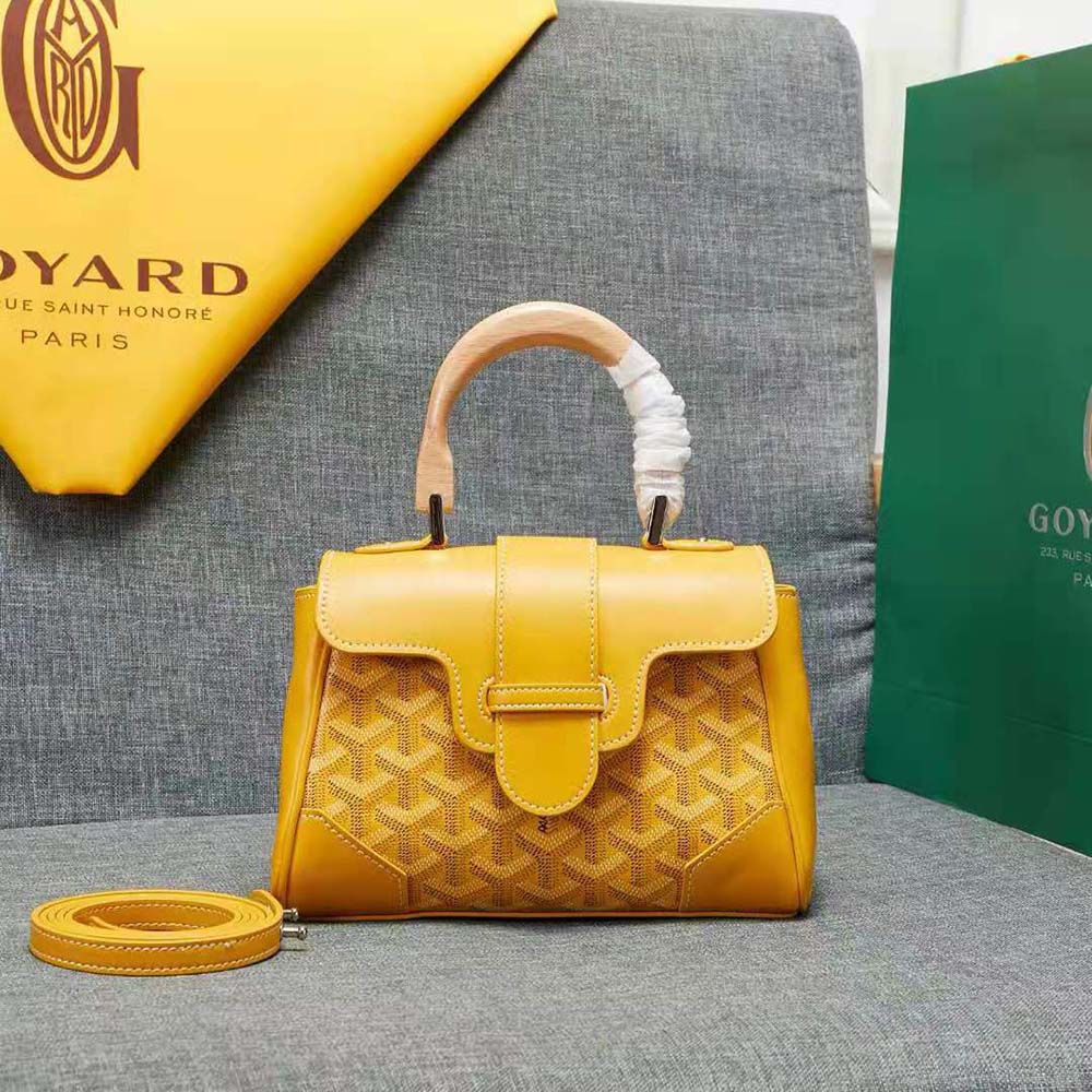 Close-up detail of signature Goyardine canvas and calfskin bag flap
