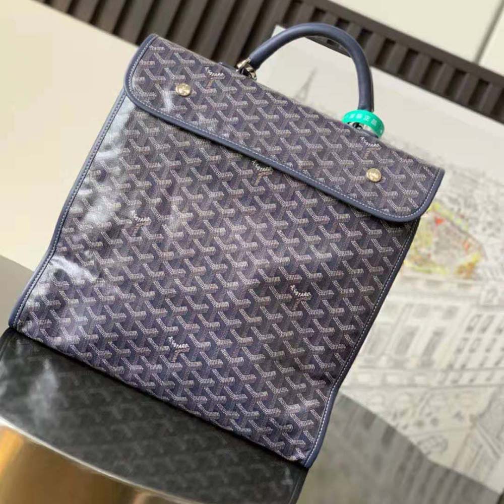 Close-up of Goyardine canvas pattern and calfskin trim on backpack