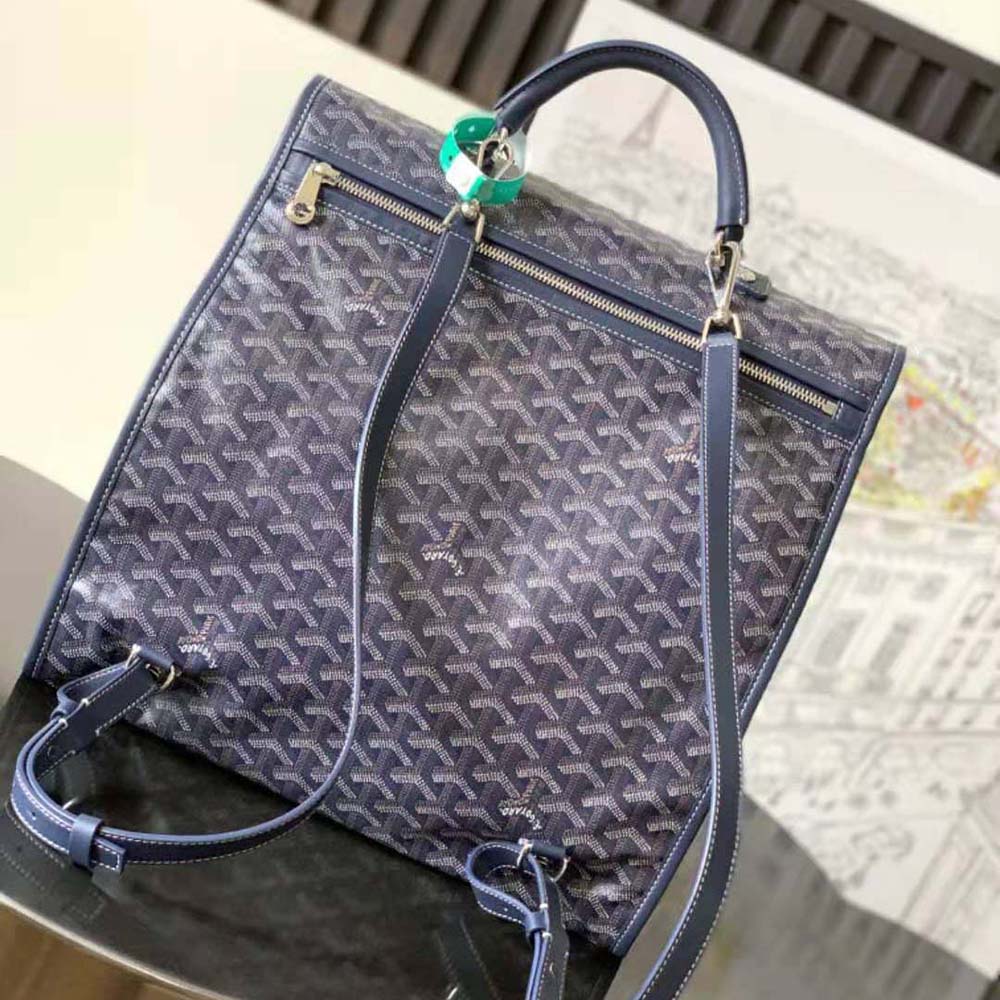 Side angle showing brass hardware and zip closure on Goyard Saint Léger Backpack