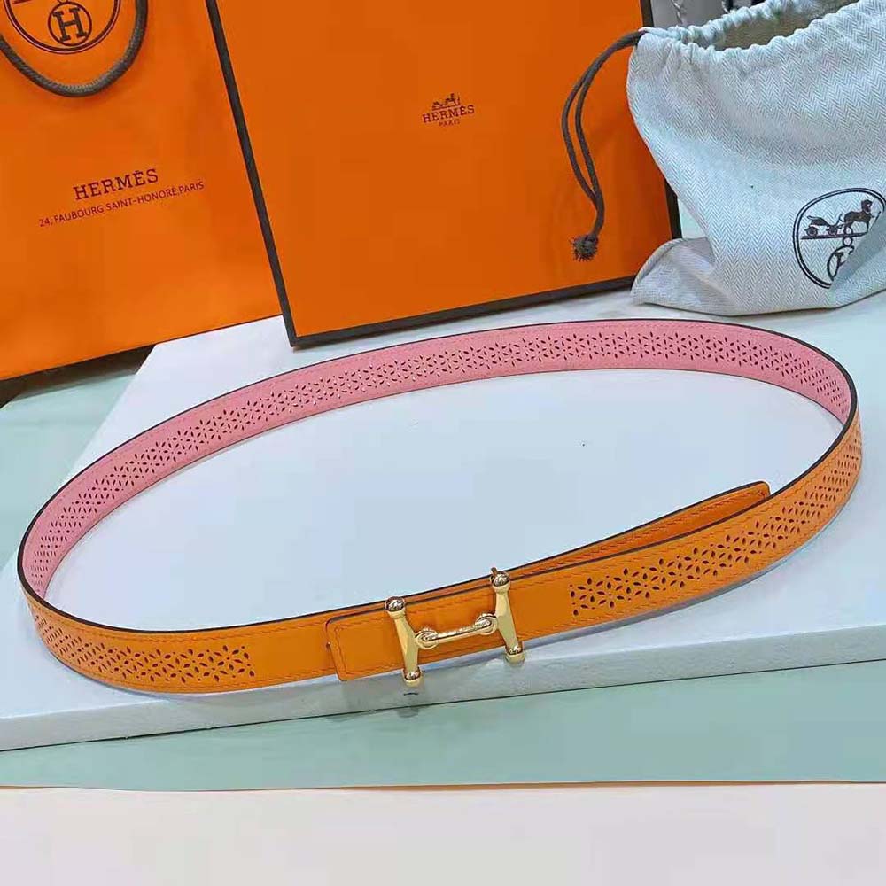 Close-up of Hermes signature H buckle on reversible orange leather strap