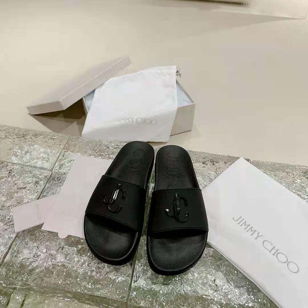 Close-up of JC monogram embossed on Jimmy Choo Women Port/F slides