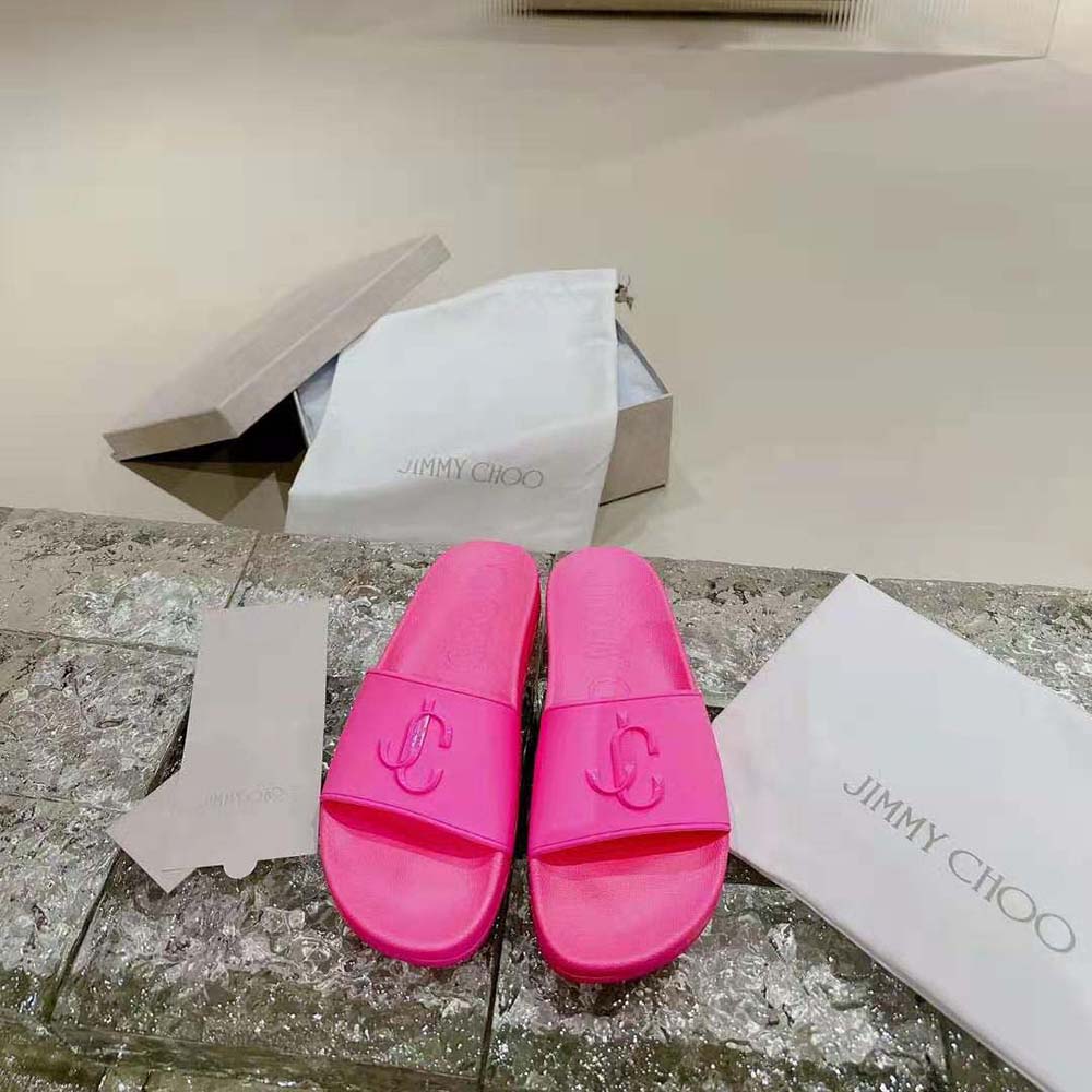 Top view showing neon pink rubber and JC monogram detail on Jimmy Choo slides