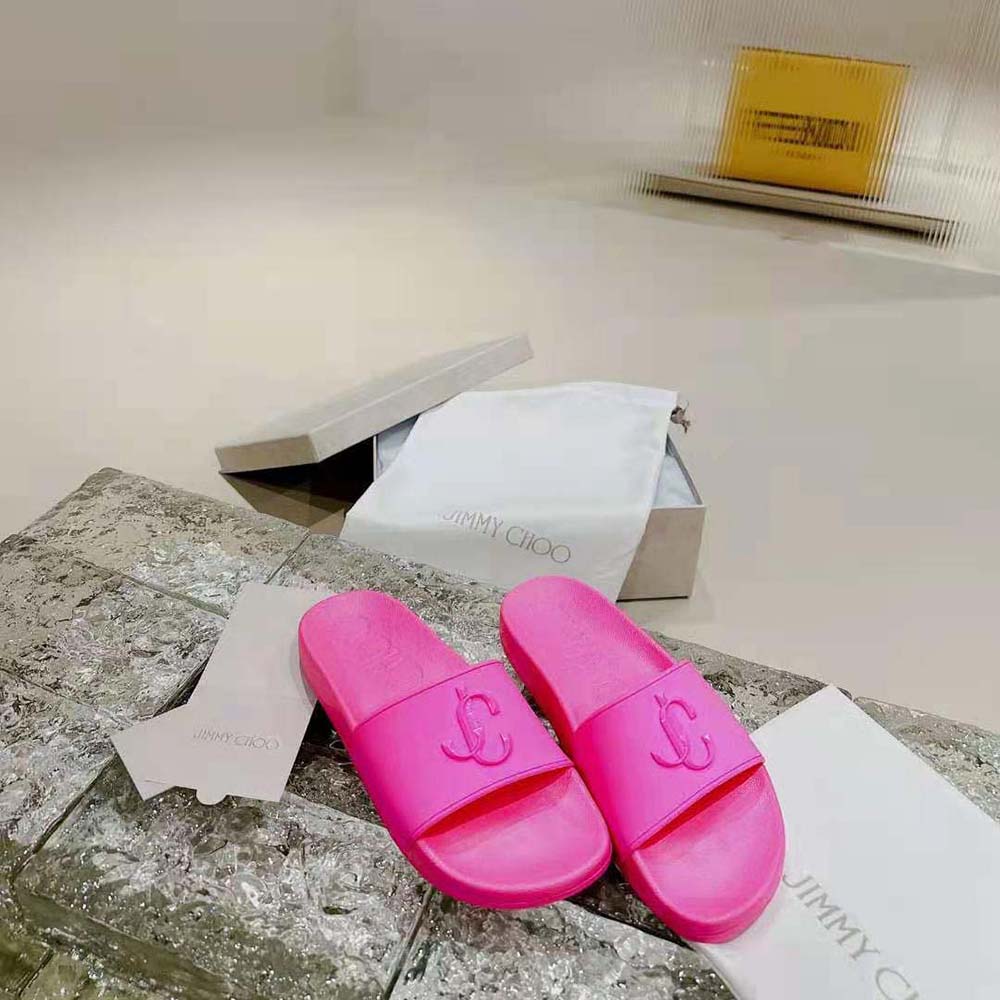 Close-up of embossed JC monogram on Jimmy Choo Women Port/F Neon Pink Rubber Slides