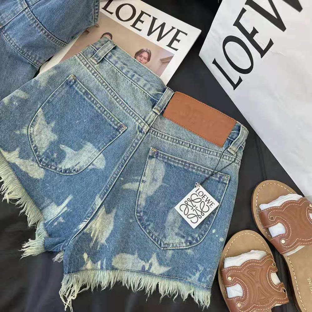 Side angle of Loewe Women Fish Shorts in Denim highlighting button closure