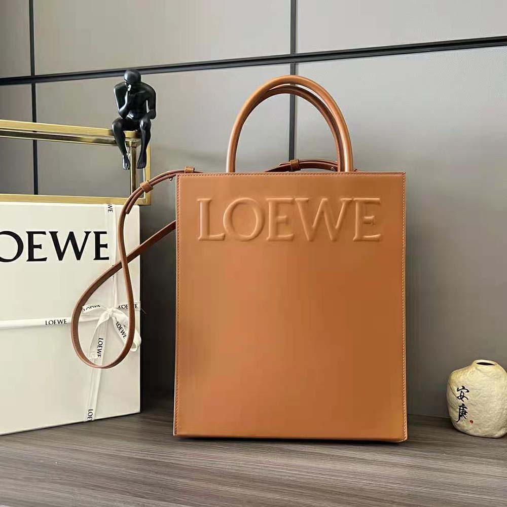 Close-up of embossed Loewe logo on tan calfskin tote leather