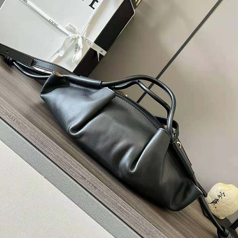 Side profile showing adjustable strap and sleek silhouette of Loewe Small Paseo Bag