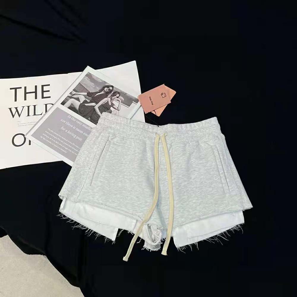 Close-up of silver embroidery detail on Miu Miu cotton fleece shorts