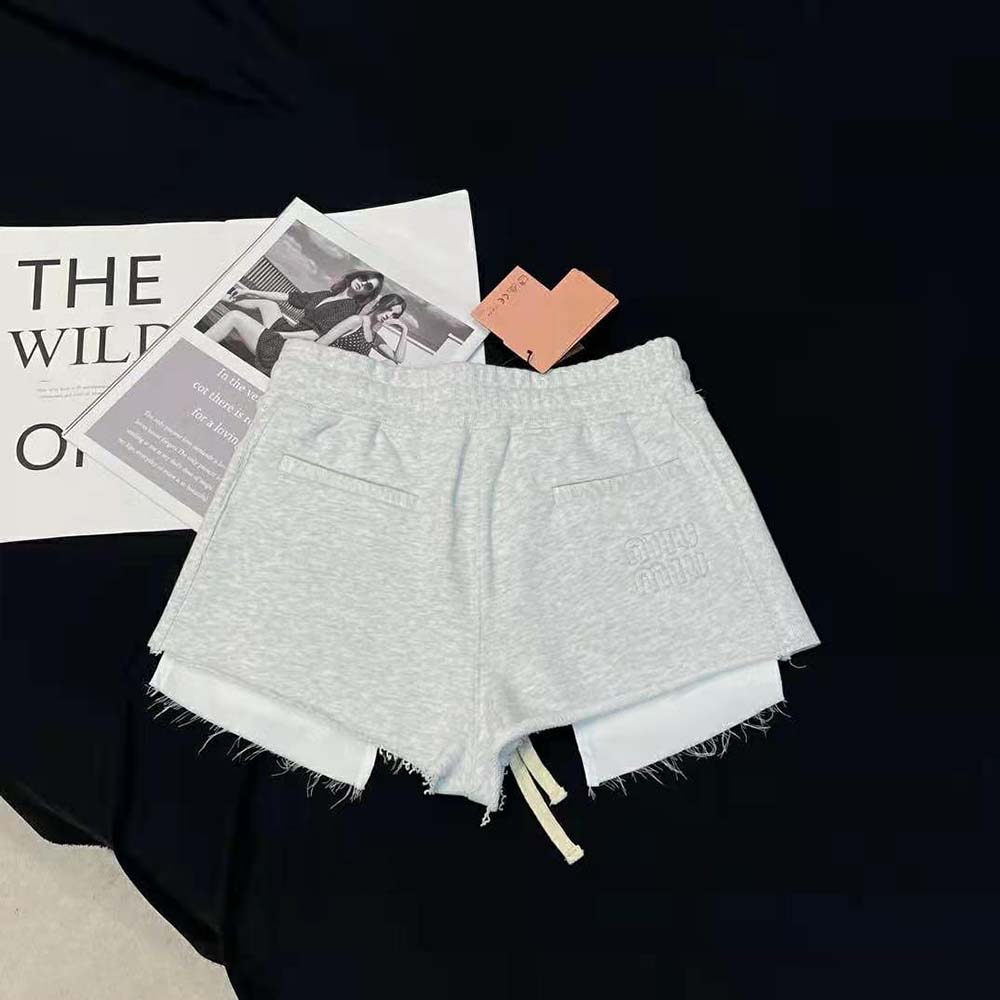 Side angle showing relaxed fit of Miu Miu Women Embroidered Cotton Fleece Shorts-Silver