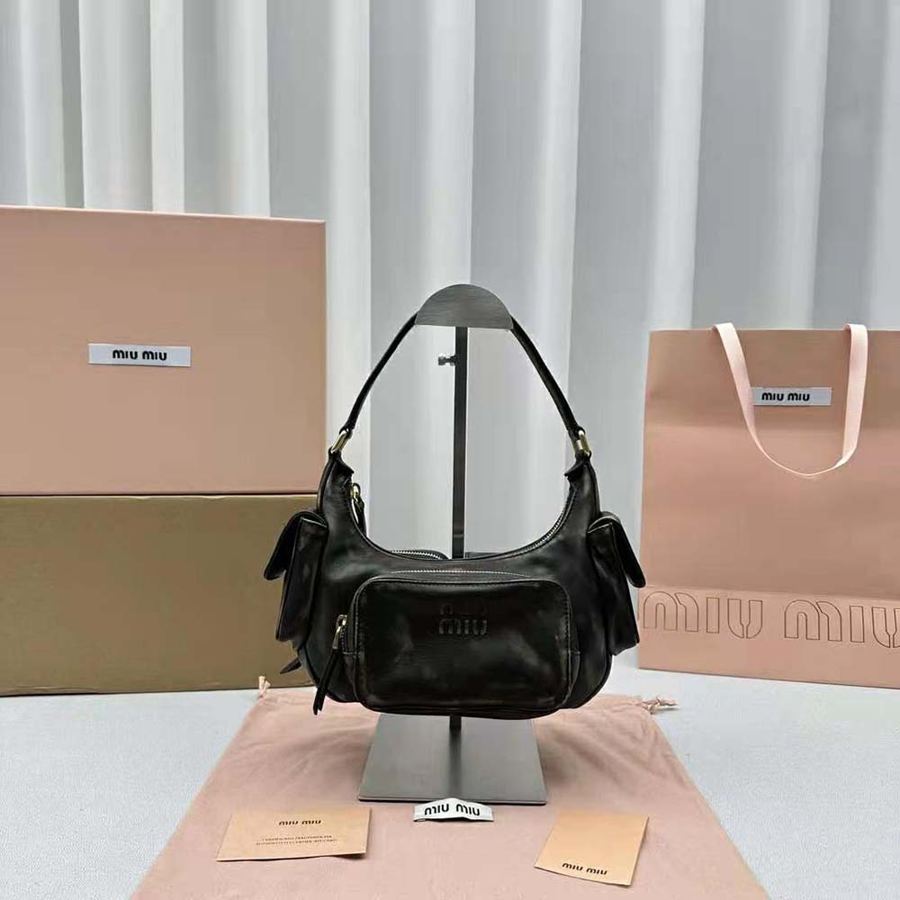 Close-up of black nappa leather texture and silver hardware on Miu Miu bag