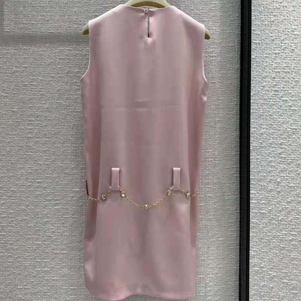 Side profile showcasing silhouette of Miu Miu satin mini-dress in pink