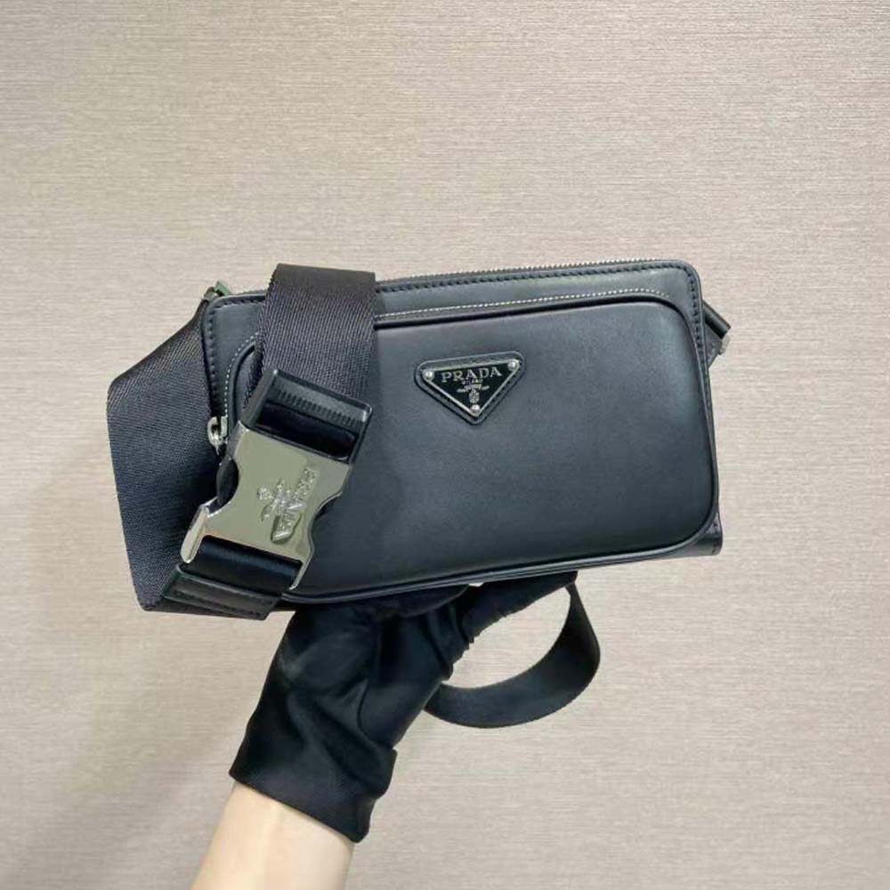 Close-up of silver-tone Prada logo hardware on leather shoulder bag