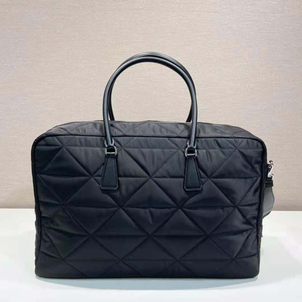 Side angle of Prada Unisex Quilted Re-Nylon Travel Bag-Black highlighting compact silhouette