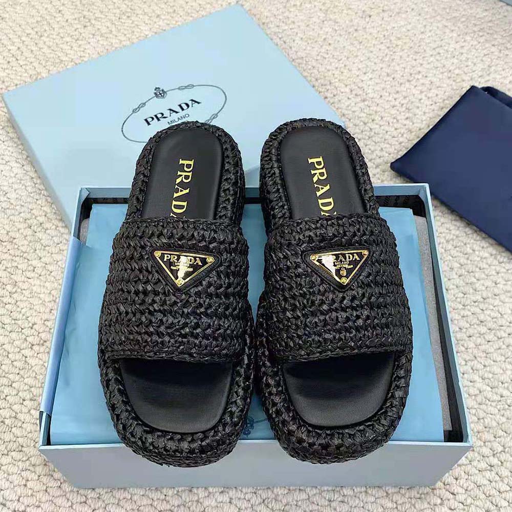 Close-up of enameled metal triangle logo on Prada Women Crochet Flatform Slides Black