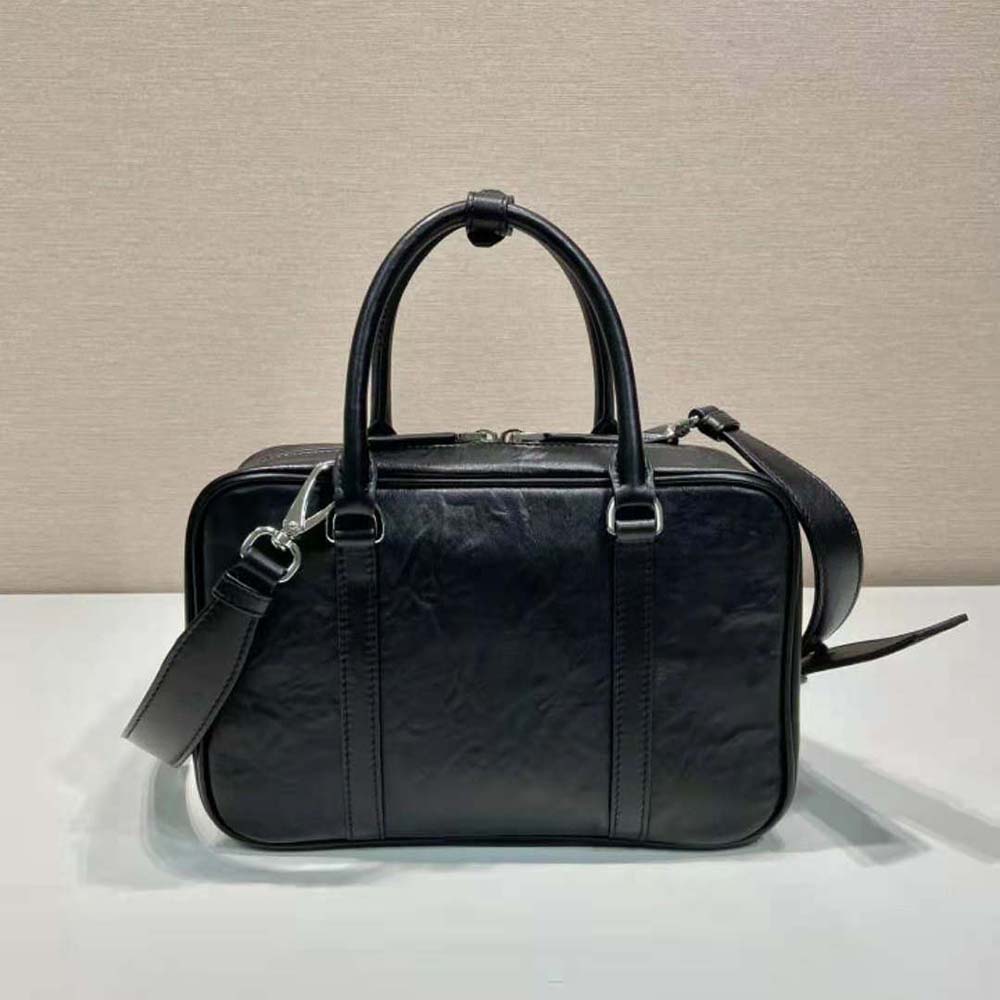 Side angle showing structured silhouette of Prada Women Medium Top Handle Bag