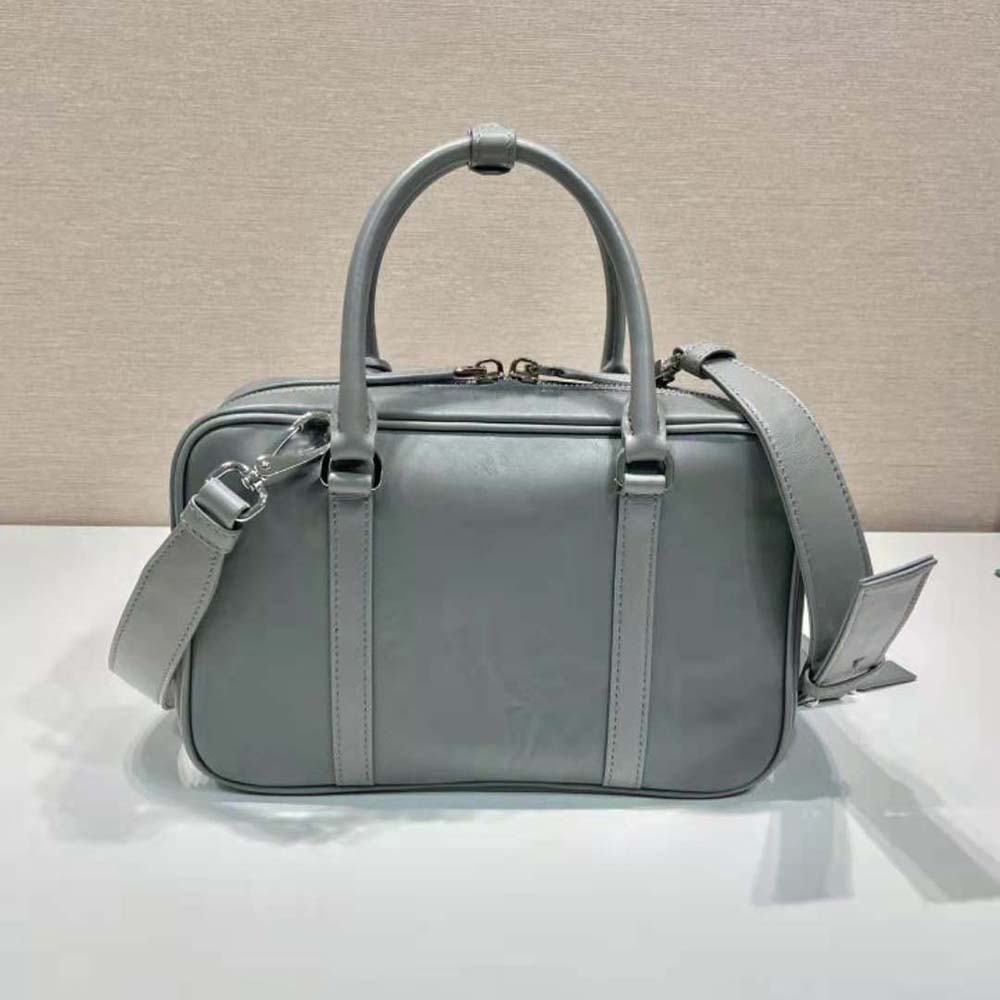 Side profile showcasing structured silhouette of Prada Women Medium Antique Nappa Leather Top Handle Bag-Gray