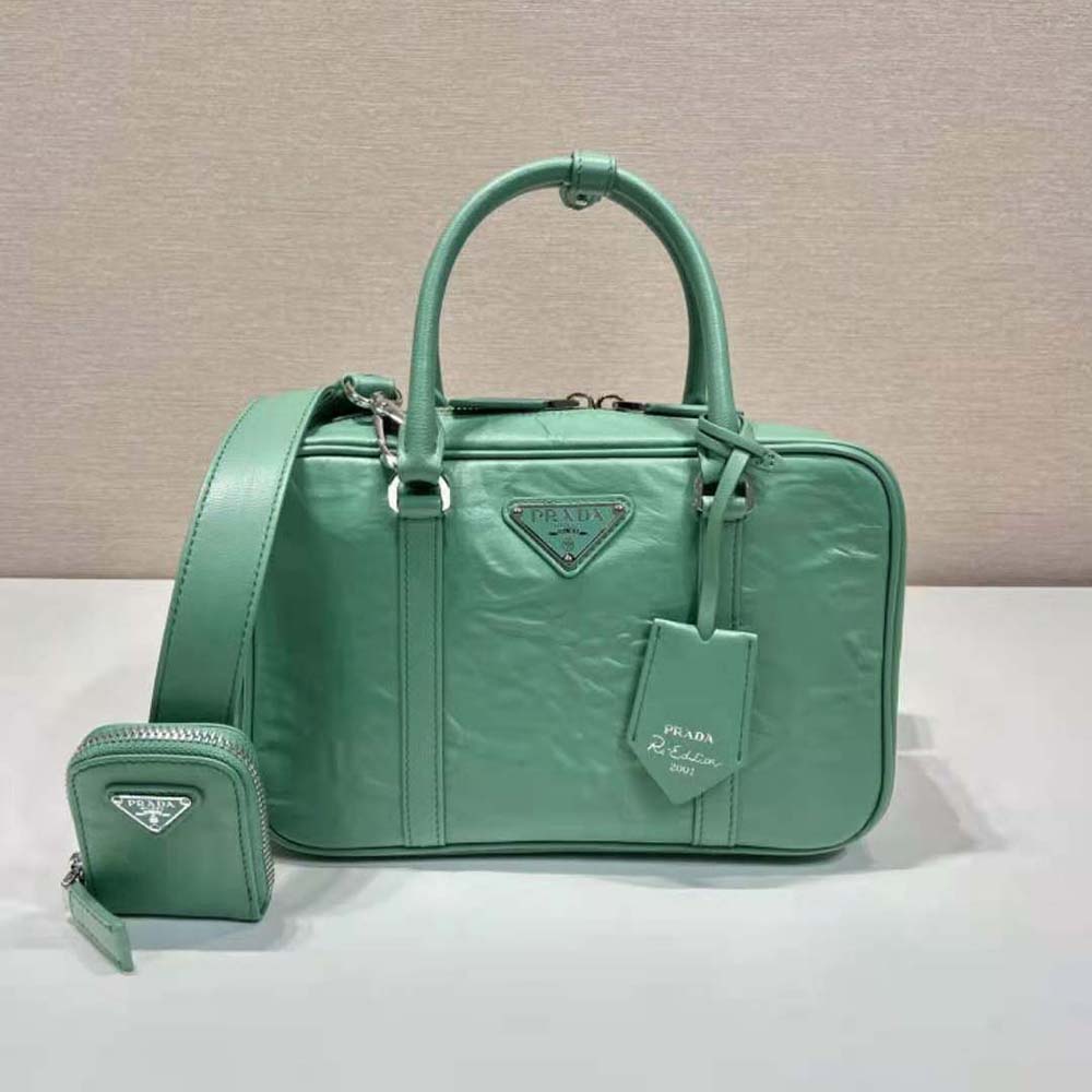 Close-up of gold-tone hardware on Prada Women Medium Antique Nappa Leather Top Handle Bag-Green