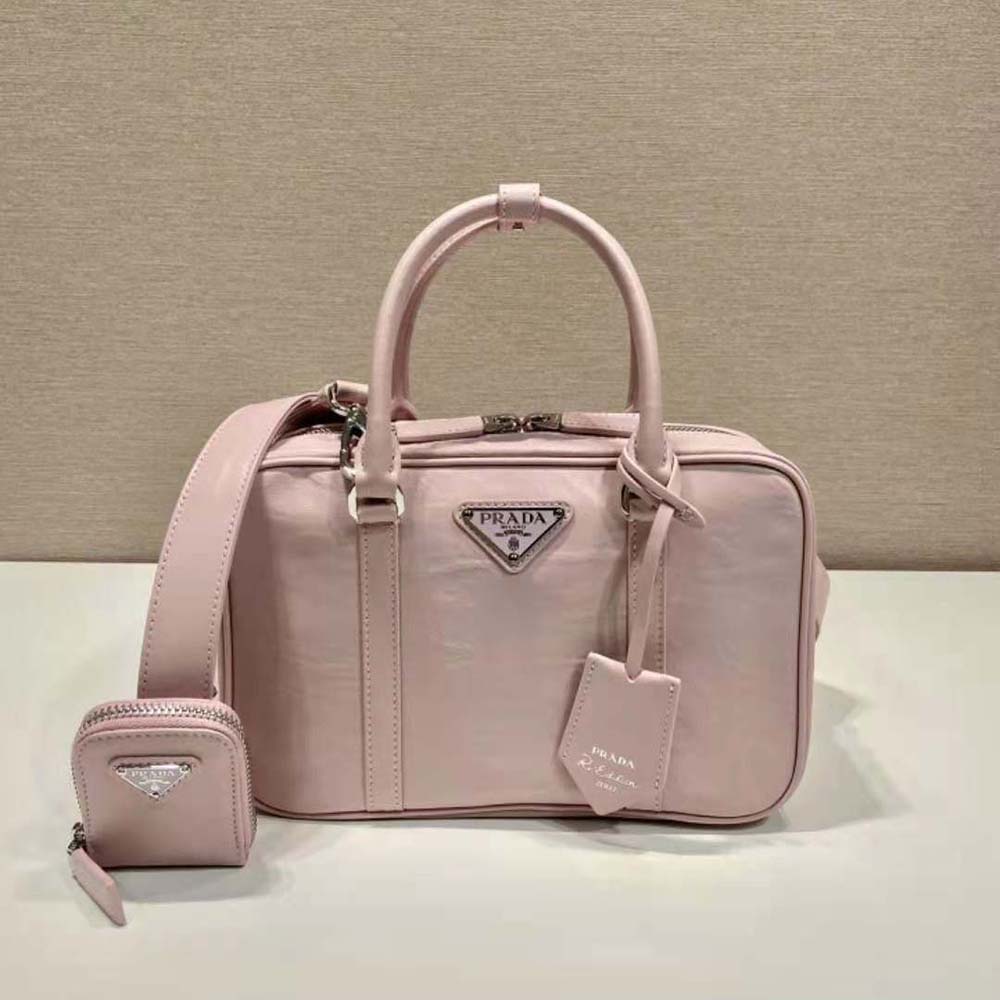 Close-up of gold-tone hardware on Prada Women Medium Antique Nappa Leather Top Handle Bag-Pink
