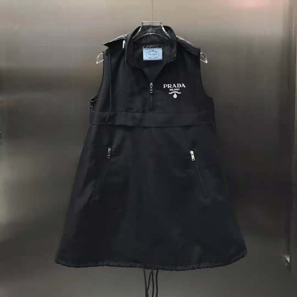 Close-up of Prada logo hardware on black Re-Nylon mini-dress