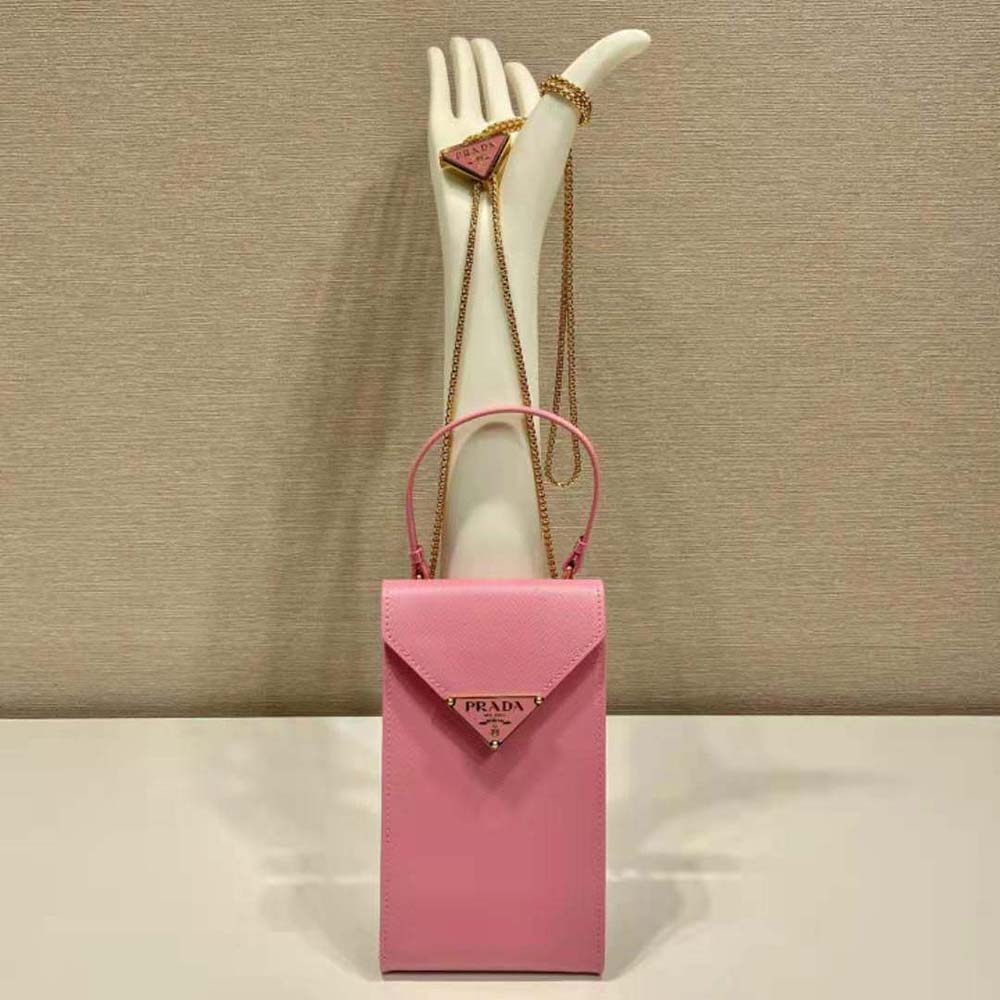 Close-up detail of pink Saffiano leather texture and gold clasp