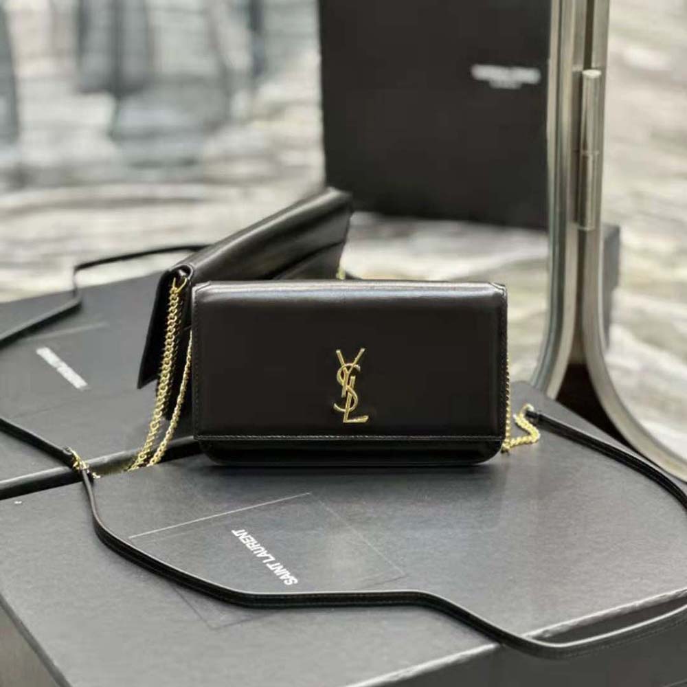 Close-up on YSL logo and silver-tone hardware on phone holder