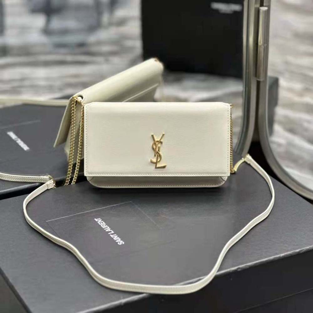 Close-up of YSL gold monogram and smooth leather texture on phone holder