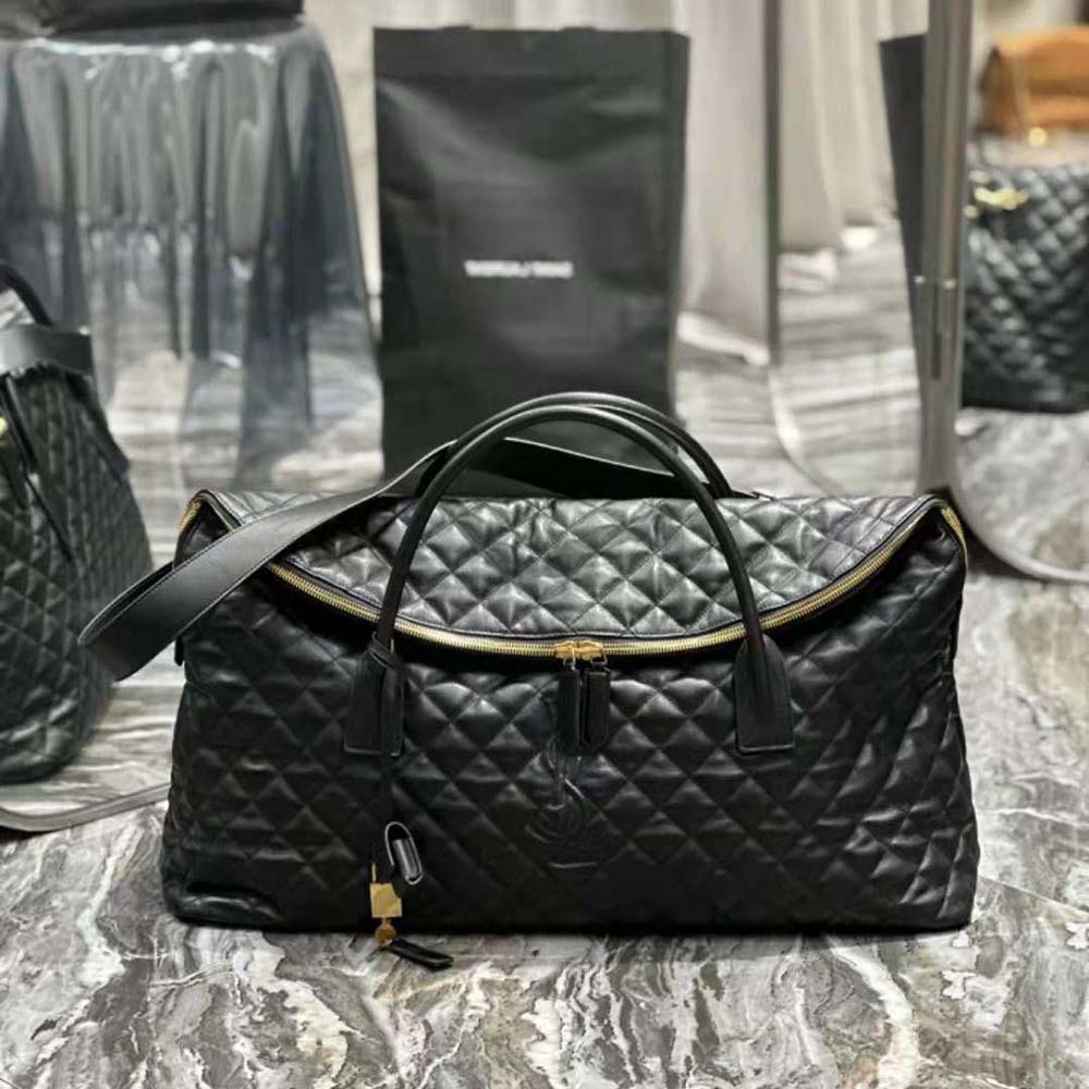 Close-up of gold YSL logo and quilted leather detail on travel bag