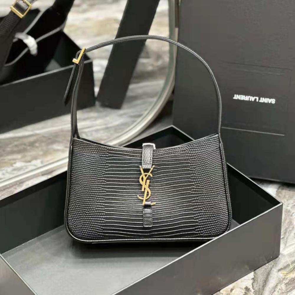 Close-up of gold YSL logo hardware on mini lizard-embossed bag