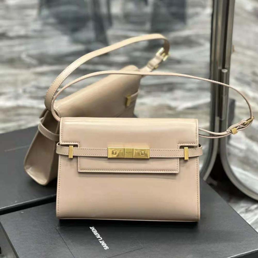 Close-up of gold YSL logo on pink leather shoulder bag