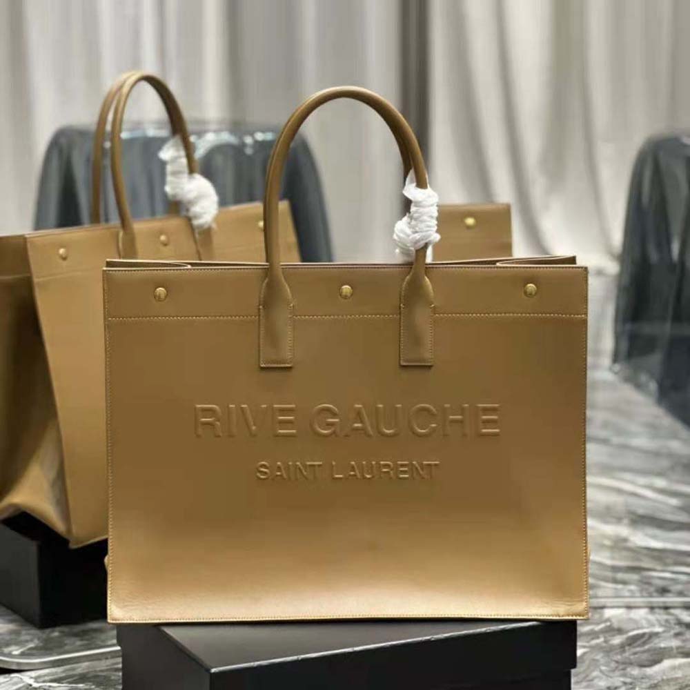 Close-up of gold-tone YSL signature hardware on large tote bag