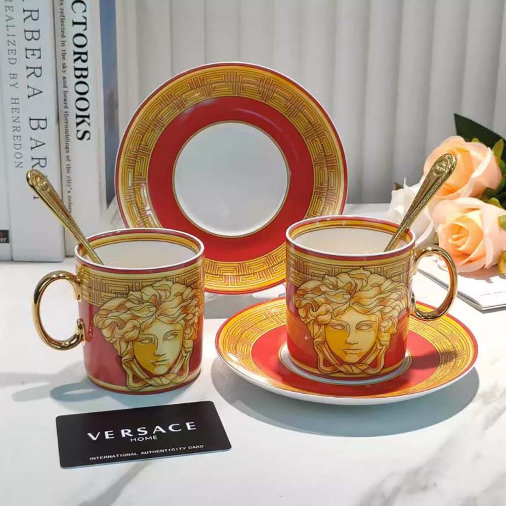 Close-up of gold Medusa detail on Versace coffee cup handle