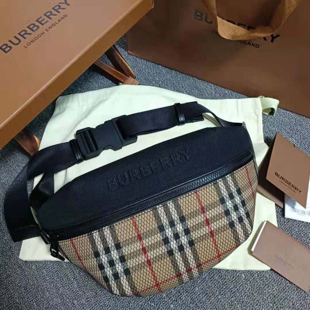 Close-up of embroidered Burberry lettering on black leather belt bag