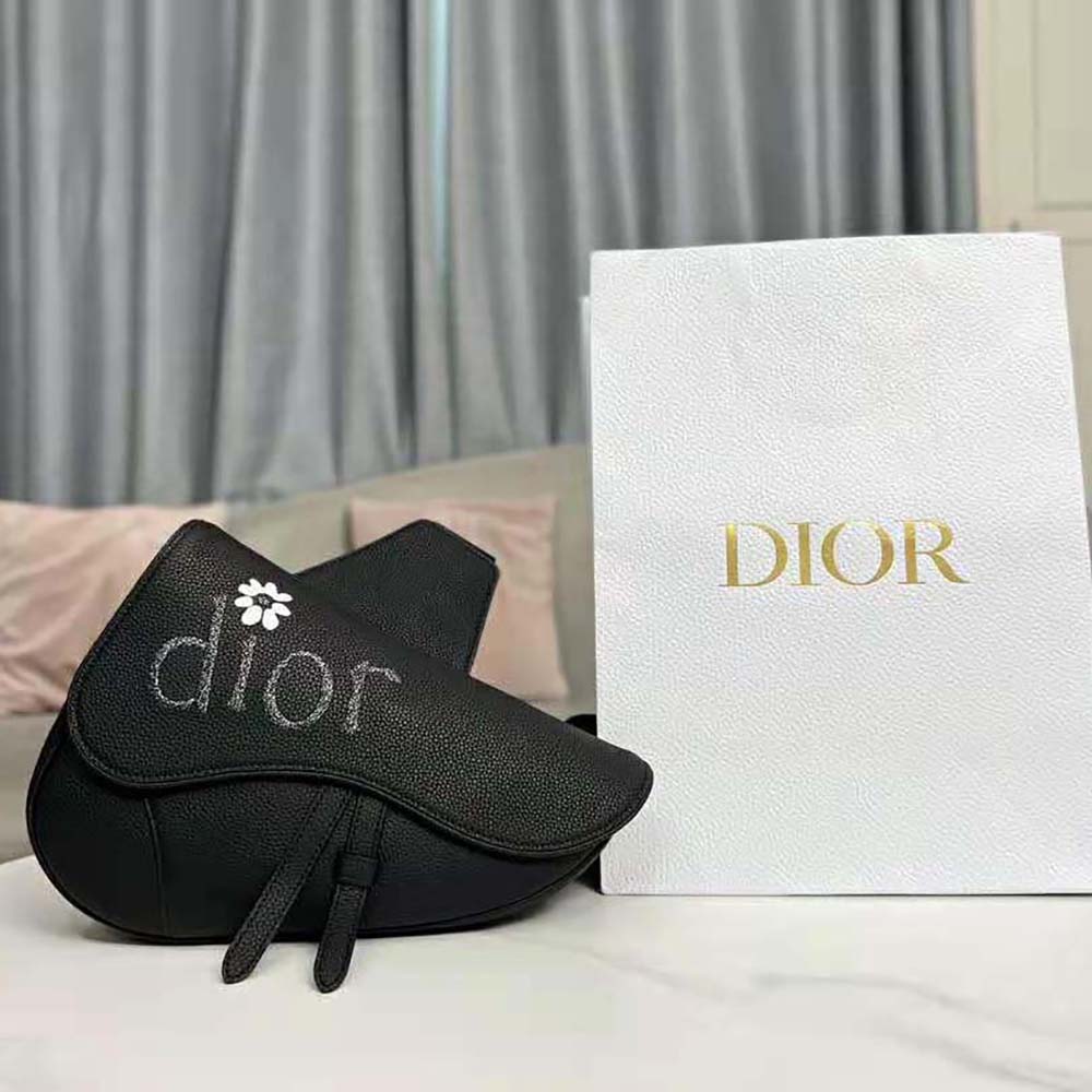 Close-up of magnetic closure and silver hardware on Dior Men By Erl Saddle Bag
