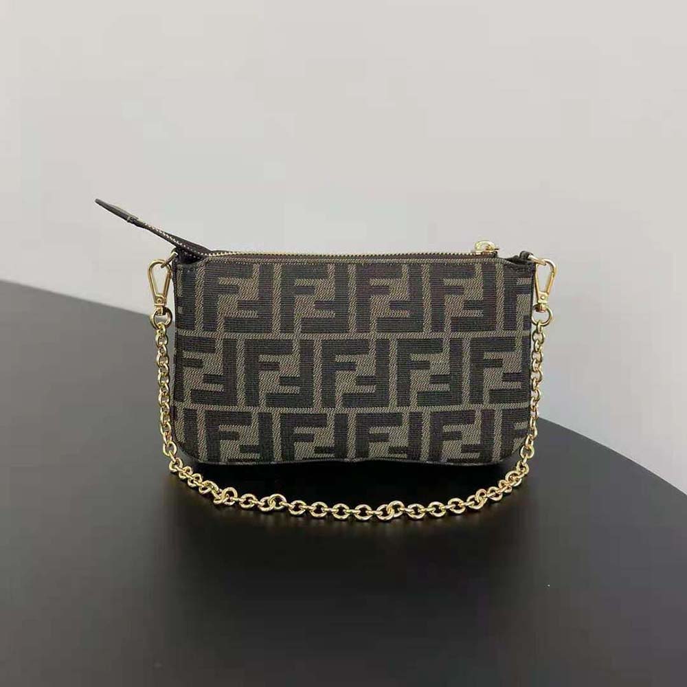Side angle showing slim silhouette of Fendi Women Baguette Pouch Brown Jacquard clutch