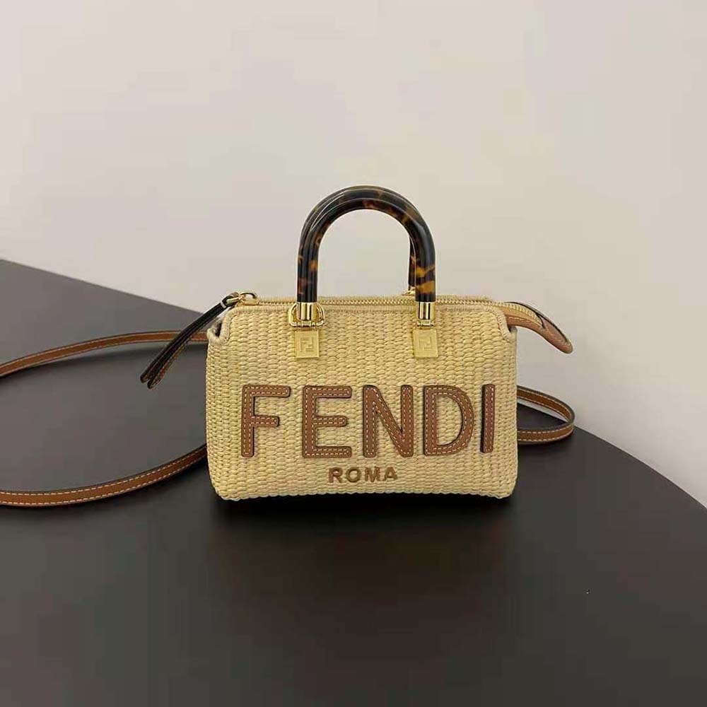 Close-up of gold Fendi logo hardware on mini natural straw Boston bag