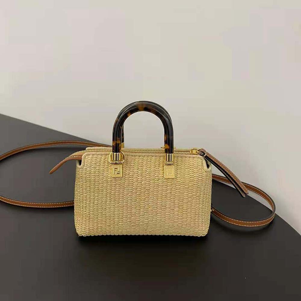 Side angle showing beige leather trim on Fendi mini natural straw bag