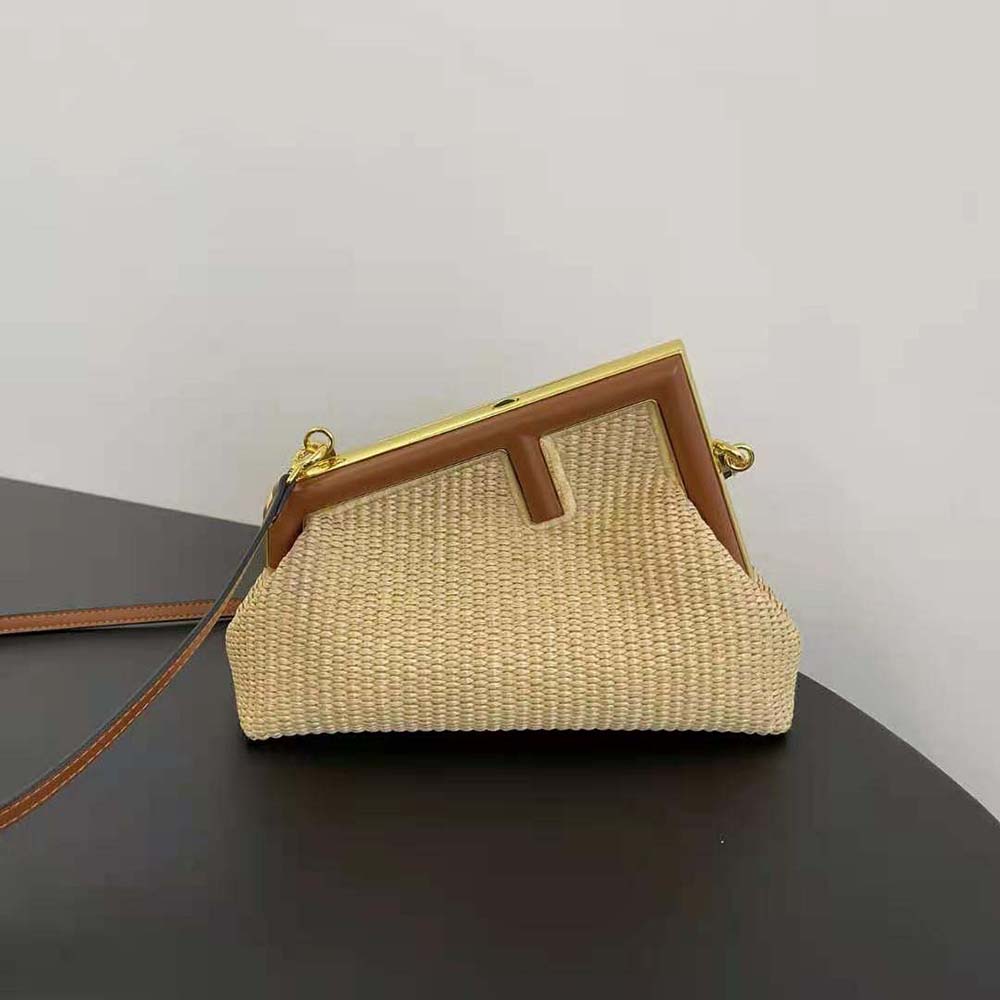 Close-up of gold hardware detail on Fendi Women Fendi First Small Natural Straw Bag