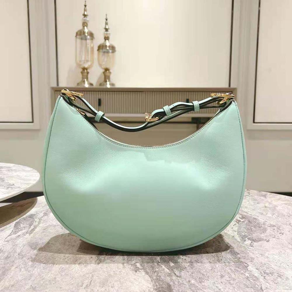 Close-up of embossed gold-tone Fendigraphy hardware on mint green leather bag
