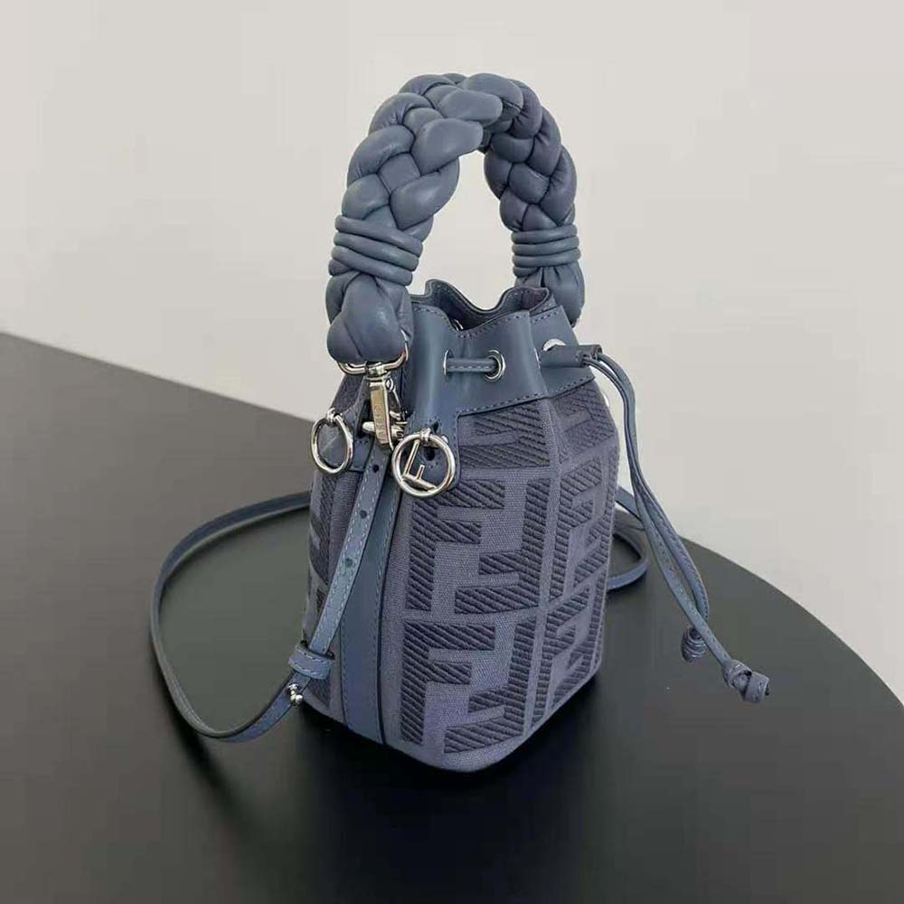 Side angle showing blue canvas and leather trim of Fendi mini-bag