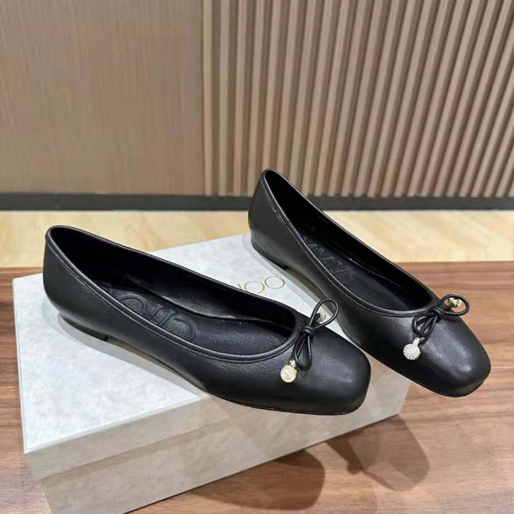 Top-down look at sleek silhouette of Jimmy Choo Elme Black Flats with pearls