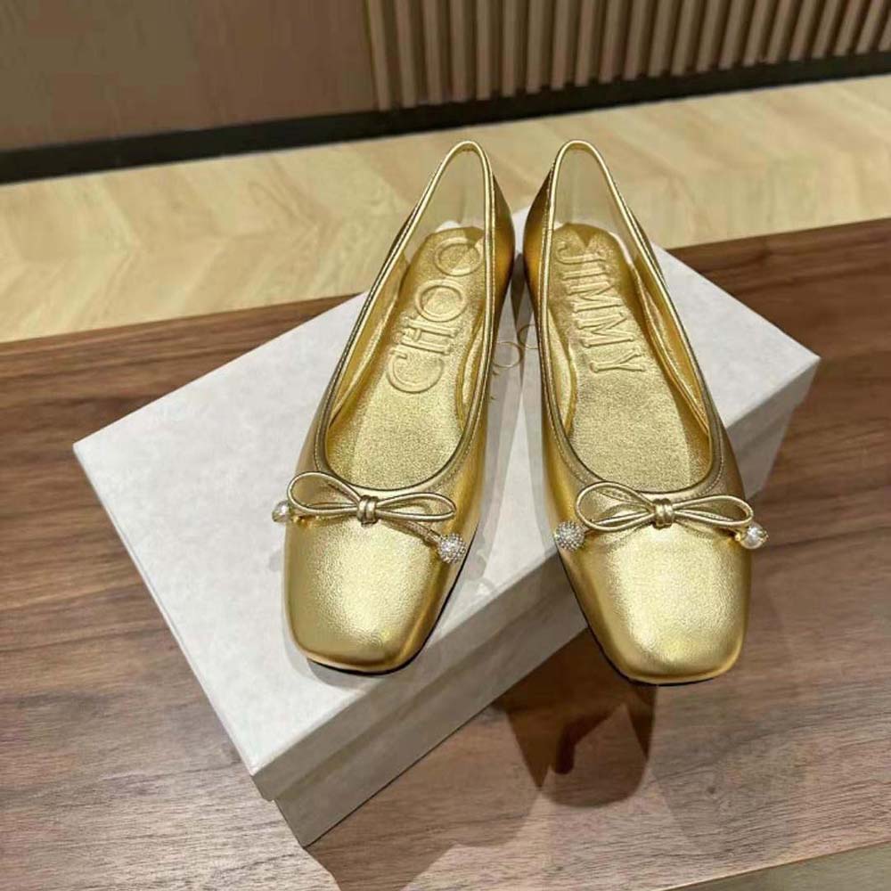 Close-up on pearl embellishment of Jimmy Choo Women Elme Flat Gold Metallic Flats