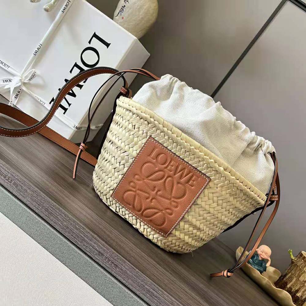 Close-up on gold-tone hardware and drawstring detail of Loewe bucket bag