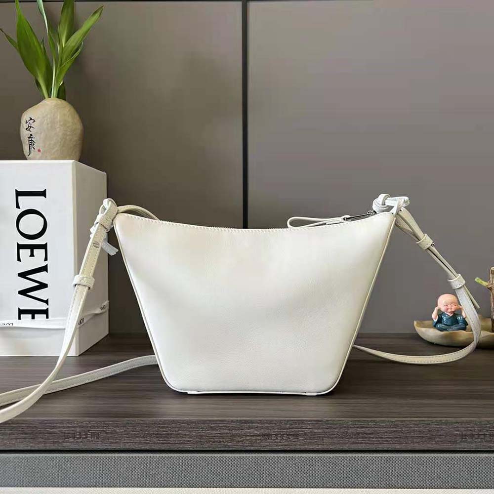 Side angle highlighting silhouette and texture of Loewe Mini Hammock Hobo Bag in white leather