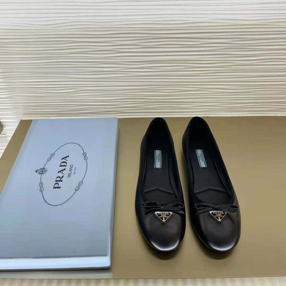 Close-up detail of Prada logo embossing on black nappa leather ballerinas