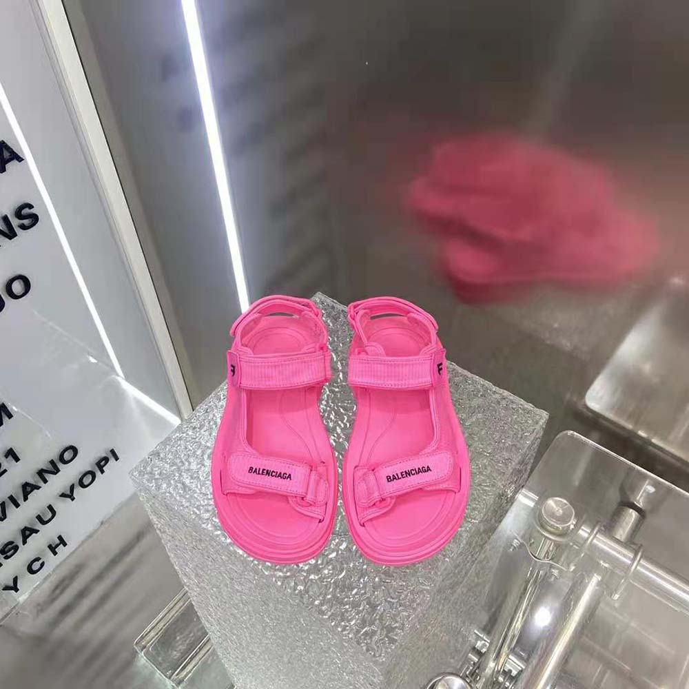 Close-up of adjustable strap and Balenciaga logo on neon pink tourist sandal