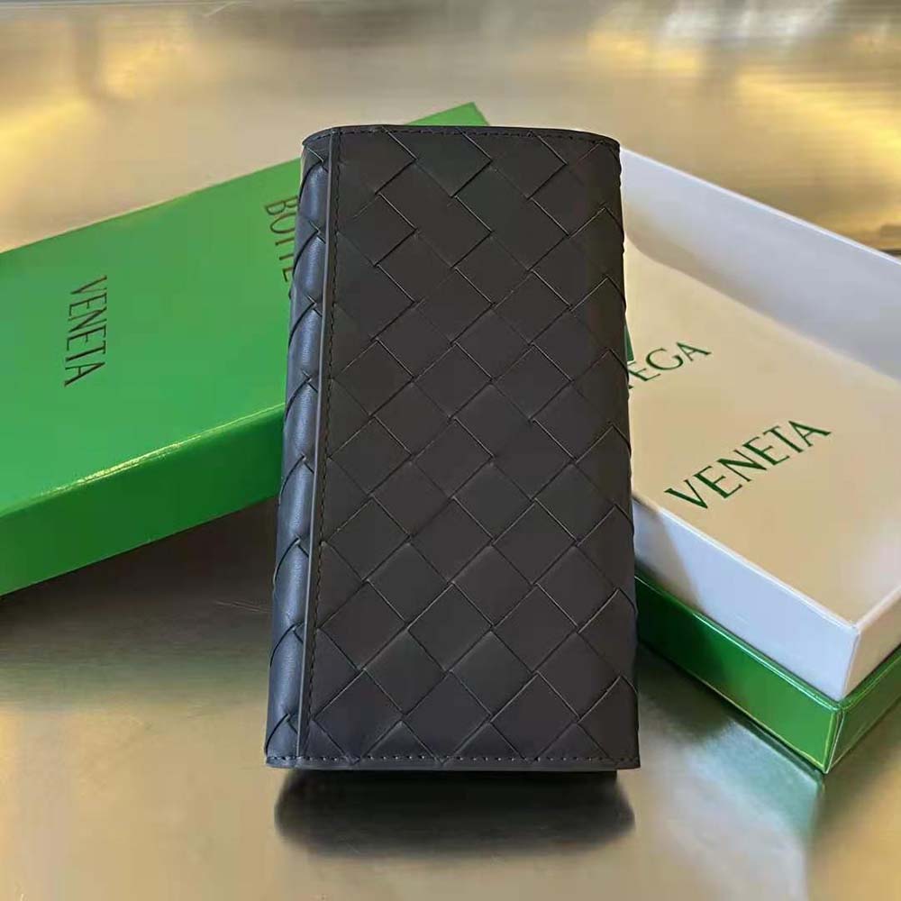 Close-up detail of black intrecciato leather on Bottega Veneta wallet