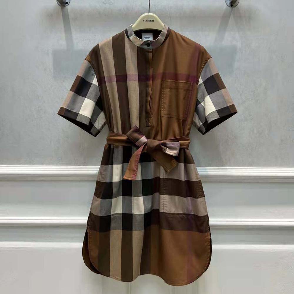 Close-up of tie waist and button details on Burberry dress