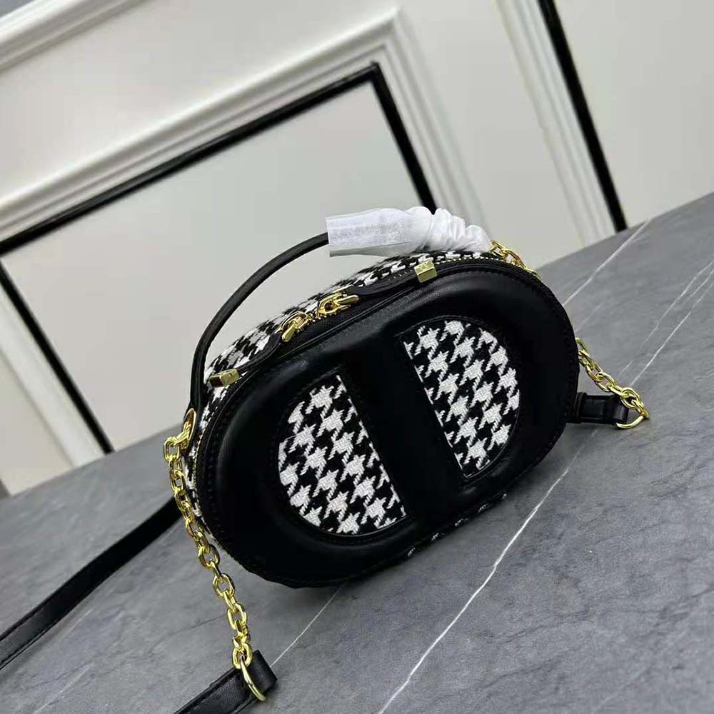 Side angle showing oval shape and zip closure of Dior Women CD Signature Bag